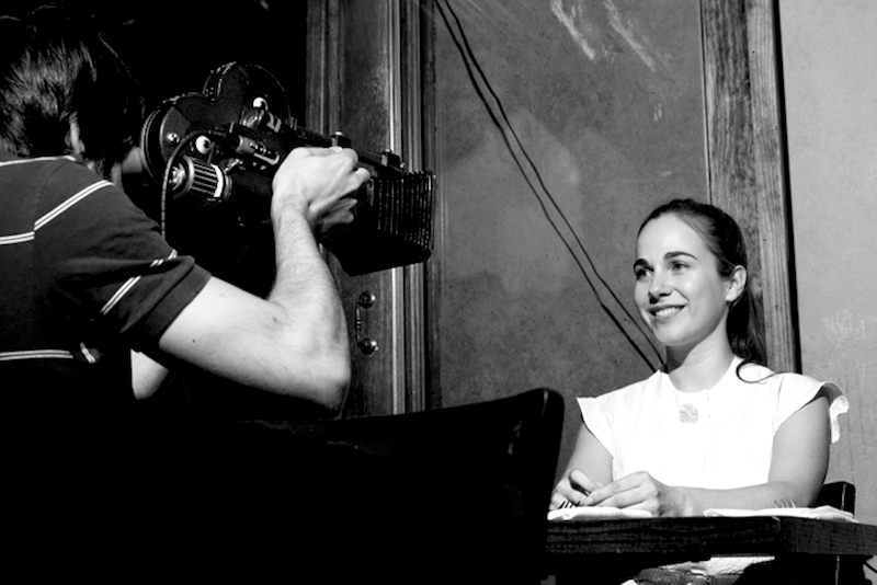 Actress posing in front of a cameraman
